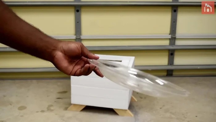 Insert the flower pot, add weed barrier and rocks.