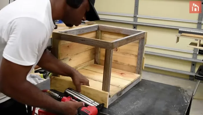 Create an interior trim using pallet pieces to support rocks.