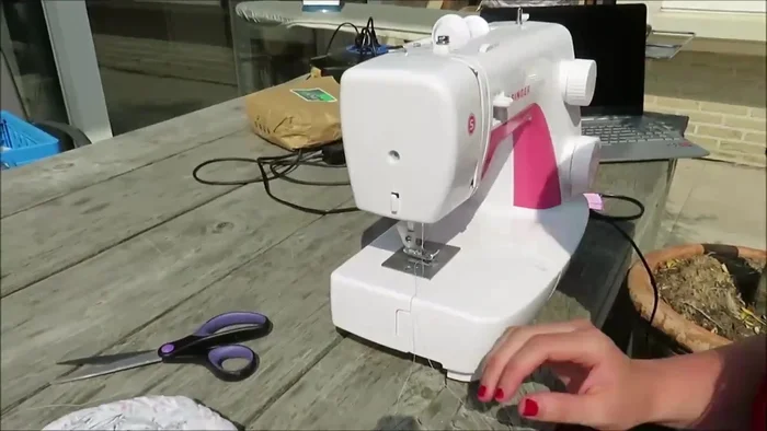 Cut and zigzag stitch the edges of the lid braid, then tuck it under the coil and sew it with a straight stitch.