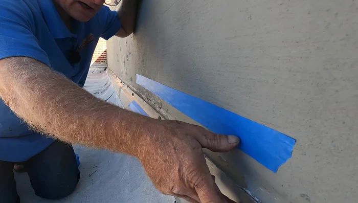 Apply tape to create a clean transition between the wall and the flashing.