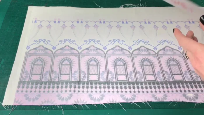 Prepare your fabric: Place your fabric wrong side up. Position the PVC sheet sticky-side down on top of the fabric.