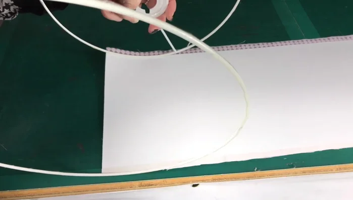 Fold and Secure Edges: Fold the raw edges of the fabric inwards and use the finishing tool to secure the fabric behind the utility rings, creating a clean, finished edge.