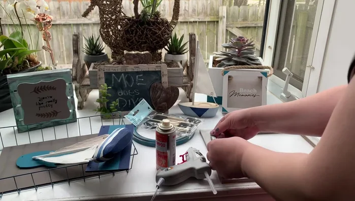 Adding seashells and sand to Target dollar spot containers.