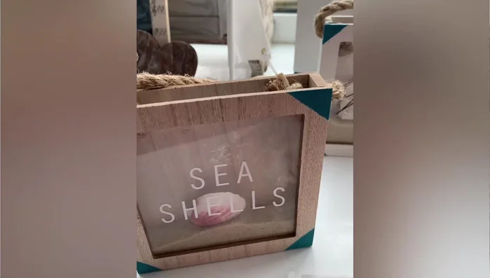 Adding seashells and sand to Target dollar spot containers.