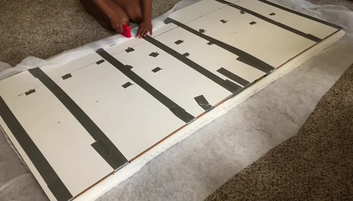 Add batting: Cut and staple batting to the back of the padded headboard base.