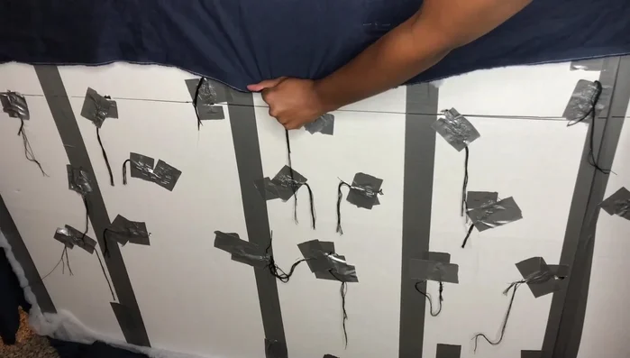 Finish and staple the fabric: Staple the edges of the fabric to the back of the headboard, pulling it tight.