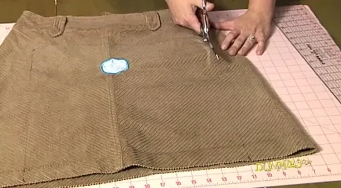 Cut along the marked lines. Fold the rectangle in half (right sides facing each other). Pin the layers together along the cut edges, placing pins diagonally at each corner and perpendicular to the edge.