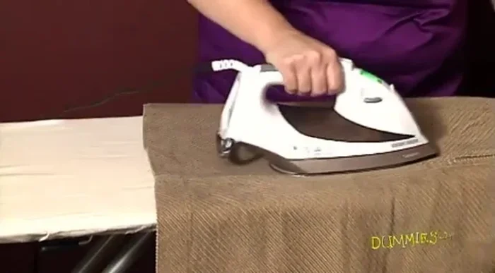 Iron your garment to lay it flat. Lay it out with the hem (bottom) farthest from you.