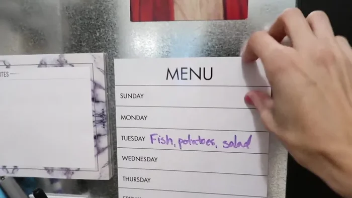 Add a menu planner and lunchbox idea area using magnet strips and notepads.