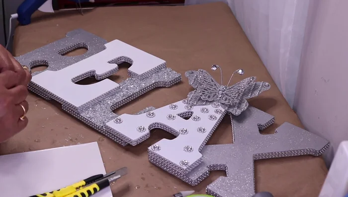 Decorate the letter 'R' with mirror tiles in a skyscraper design, adding glitter for extra bling.