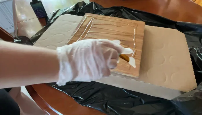 Spread the resin evenly using a silicone brush and fingers.