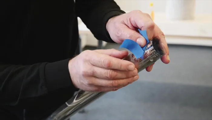 Wet the window, place the film roll onto the window, and unroll it, removing the tape.