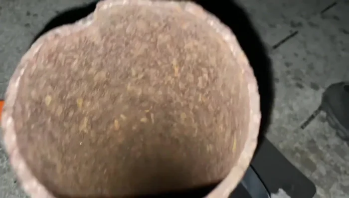 Place the rubber boot over the existing cracked seal, ensuring it covers the damaged area completely.