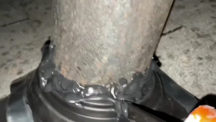 Seal the edges of the rubber boot to the roof using more sealant, creating a waterproof barrier.