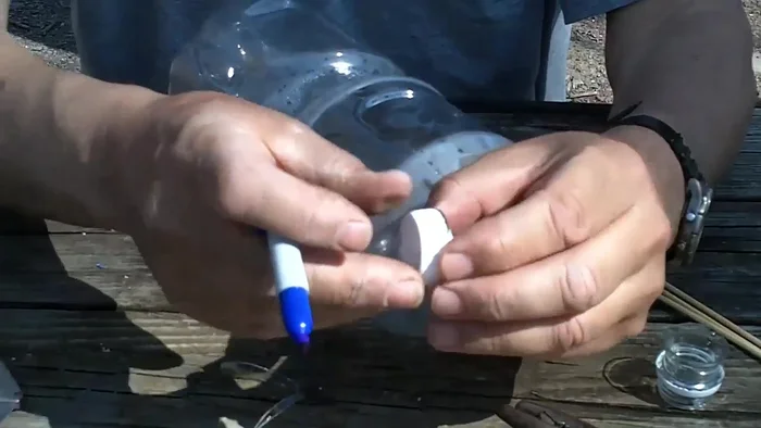 Drill a 1/8 inch hole just below the feeding port on both sides.