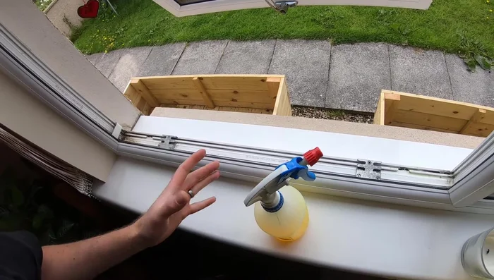 Spray cleaning solution into all window tracks. Let it sit for a few minutes to loosen dirt.