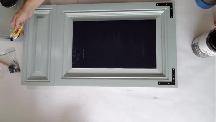 Bend the basket hooks straight and insert them through the holes.