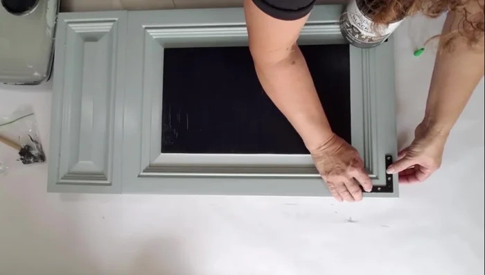 Bend the basket hooks straight and insert them through the holes.