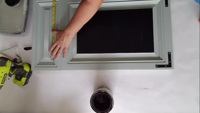 Bend the basket hooks straight and insert them through the holes.