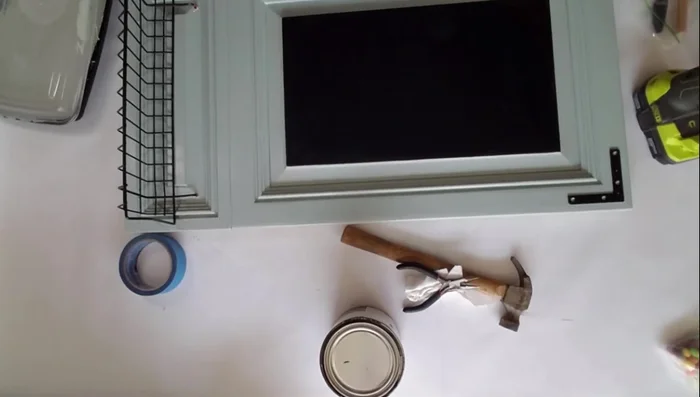 Bend the basket hooks straight and insert them through the holes.