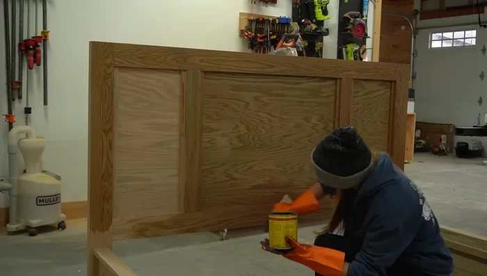 Finish the Bed: Stain all parts using Minwax Weathered Oak stain. Seal with a clear coat. Add drawer knobs. Assemble the final bed structure.