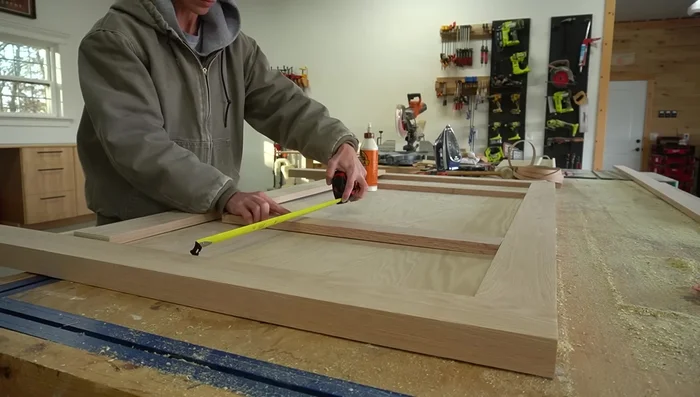 Add Trim to Headboard and Footboard: Glue and clamp 1x4 and 1x3 trim pieces onto the front of the panels.