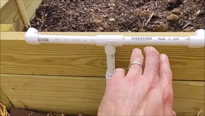 Lay the 1/2 inch pipes along the length of each bed.