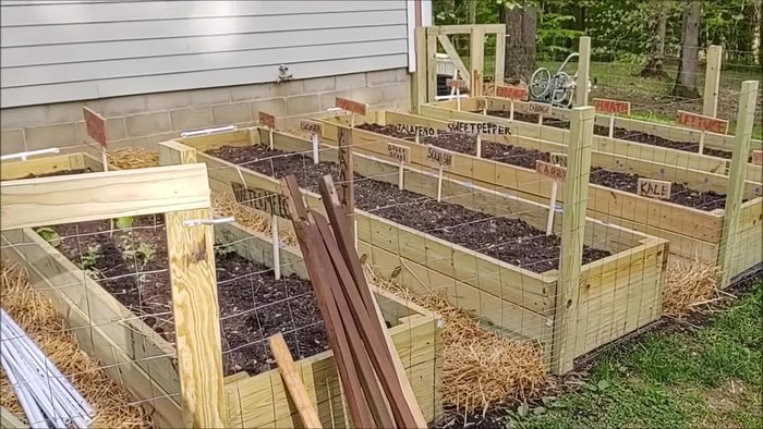 Prepare the garden beds and install fencing and pathways.