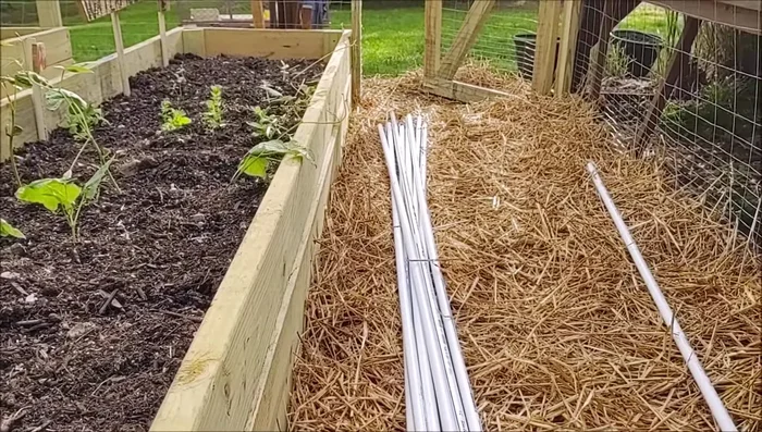 Lay the 1/2 inch pipes along the length of each bed.