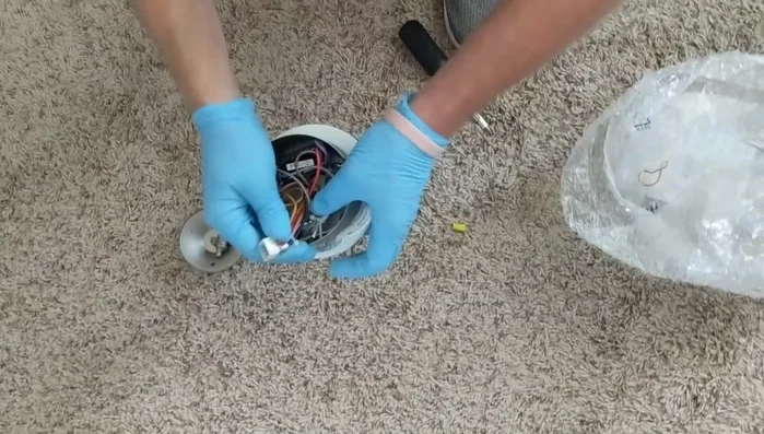 Reattach the ceiling fan housing and tighten the screws.