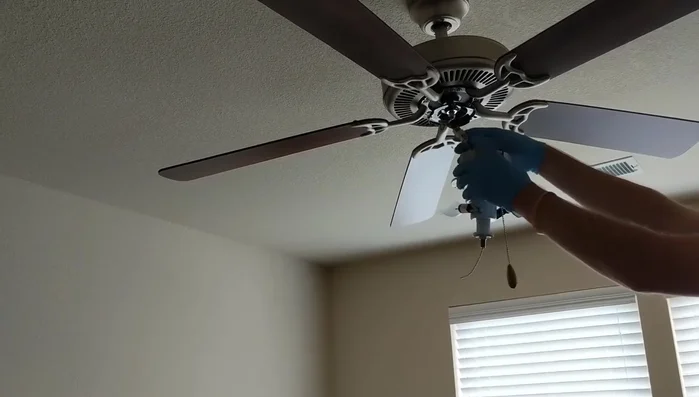 Reattach the ceiling fan housing and tighten the screws.