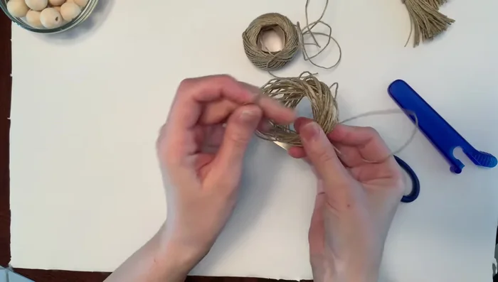 Secure tassel head: Cut another piece of twine, wrap it tightly around the tassel head, double knot, and trim the ends.