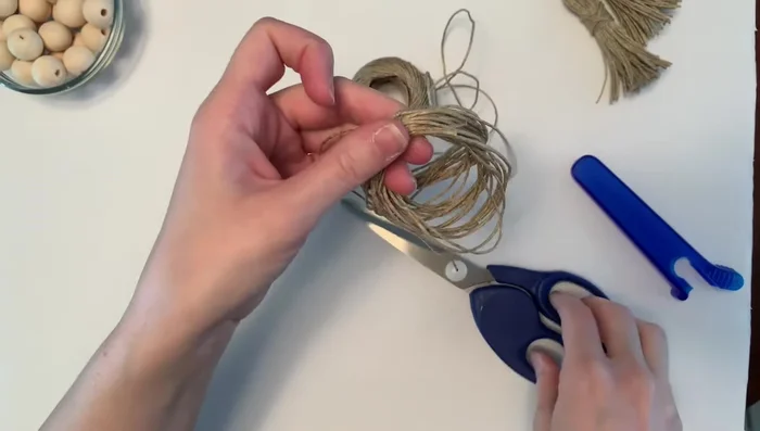 Secure tassel head: Cut another piece of twine, wrap it tightly around the tassel head, double knot, and trim the ends.