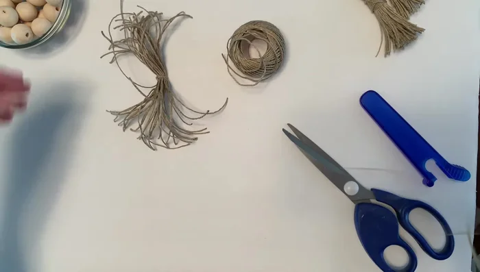 Secure tassel head: Cut another piece of twine, wrap it tightly around the tassel head, double knot, and trim the ends.