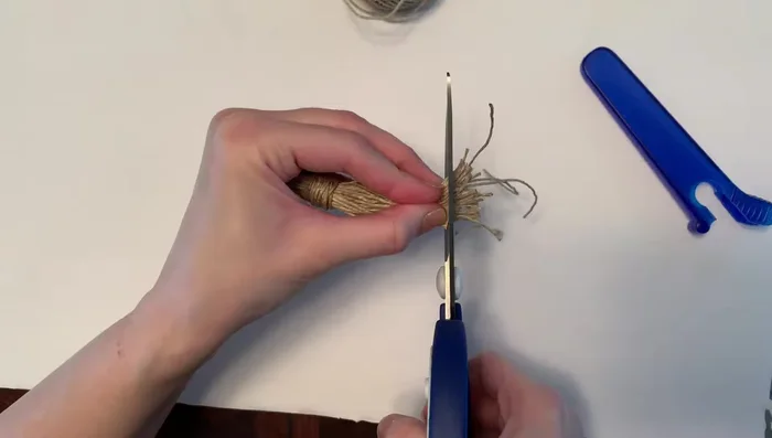 Trim tassel ends: Trim the ends of the tassel to make them neat.