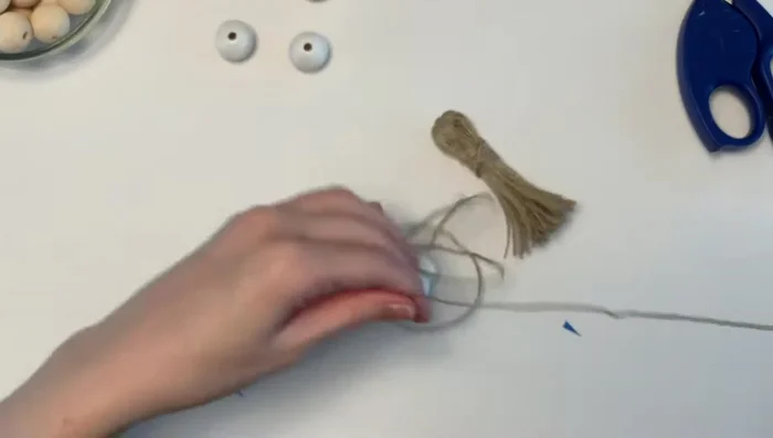 String beads: Add the three half-painted beads, 25-30 natural wood beads, and the remaining three half-painted beads to the twine.