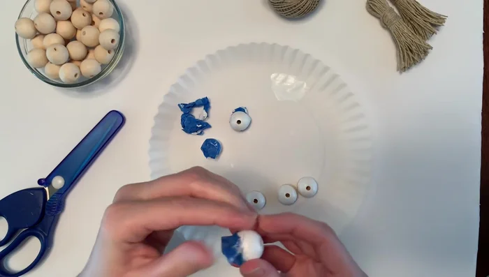 Remove tape: Carefully remove the blue painter's tape from the dried beads.