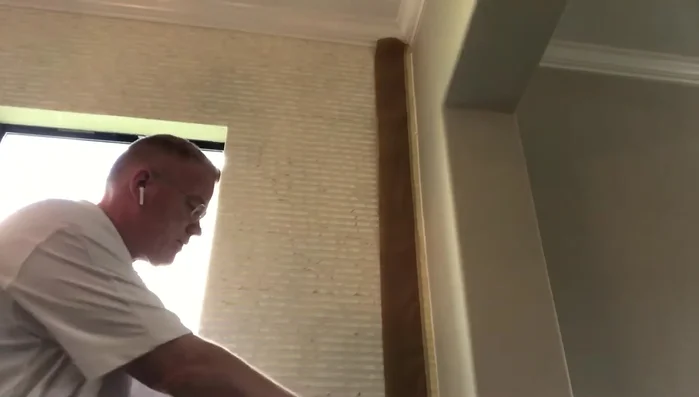 Wipe away excess caulking with a wet rag, maintaining a smooth surface.