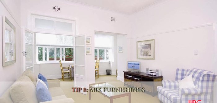 Mix furniture of various sizes and textures for visual interest, while maintaining balance.