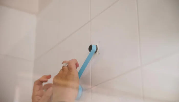 If installing a new cover plate, attach it before the shower head.