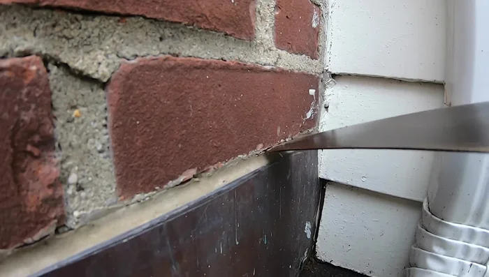 Check the caulking around the chimney base. Even if the flashing itself seems intact, loose or deteriorated caulking allows water to seep behind it.