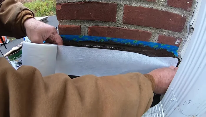 Remove the tape after the sealant has dried. This reveals a clean and professional-looking repair.