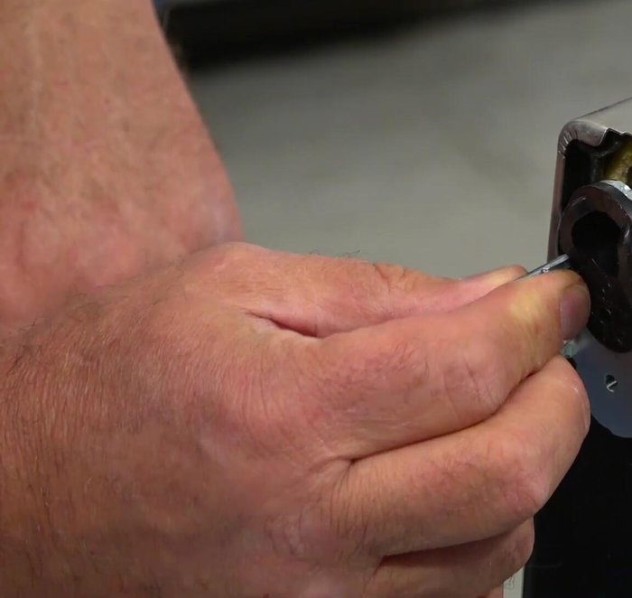 Slide the new door stopper assembly into the opening, align the holes, and secure it with the Phillips screws.
