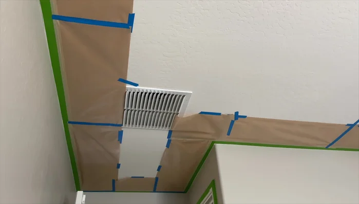 Install smooth vinyl panels on the first accent wall, spray painting them with Sache Sand for a cohesive look.