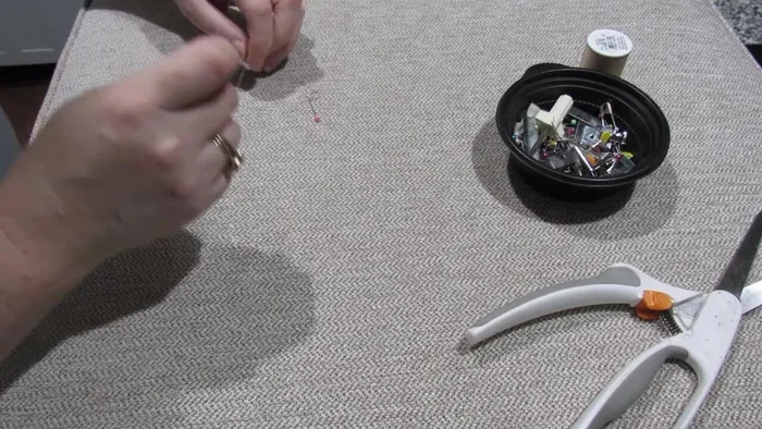 Using an over stitch, secure the patch to the damaged fabric, ensuring stitches are hidden within the pile of the material.