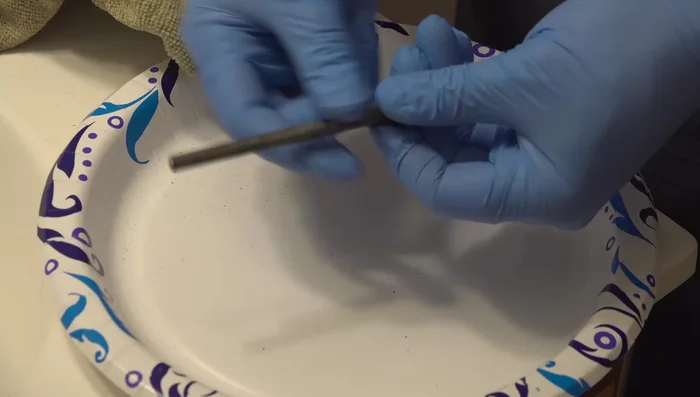 Lightly sand any rust or pitting on the pin for a smoother surface.