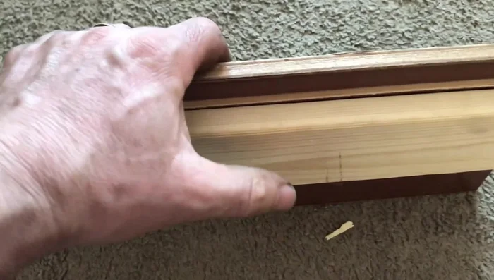 Screw the repair piece to the drawer back, ensuring it's flush with the existing surface. Drill from the back into the repair piece to add screws.