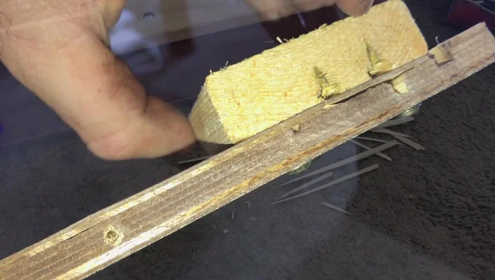 Use a longer screw where the board originally split for improved stability and to reach deeper into the wood. Tighten by hand to prevent splitting.