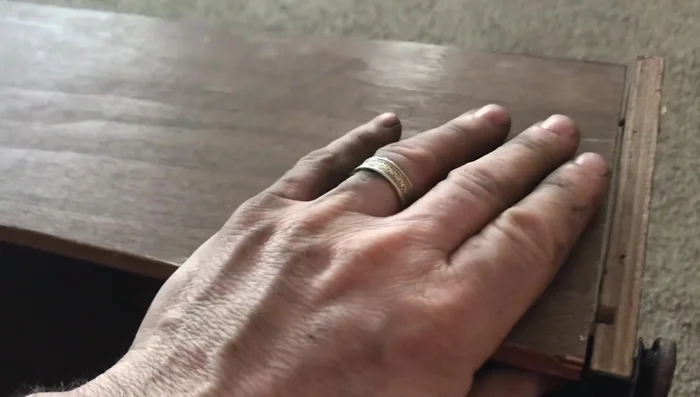 Screw the repair piece to the drawer back, ensuring it's flush with the existing surface. Drill from the back into the repair piece to add screws.