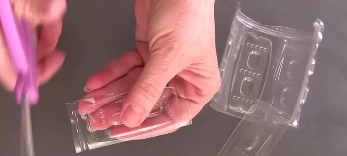 Cut the plastic bottle into desired shapes and sizes for your room divider. Round the edges for a finished look.